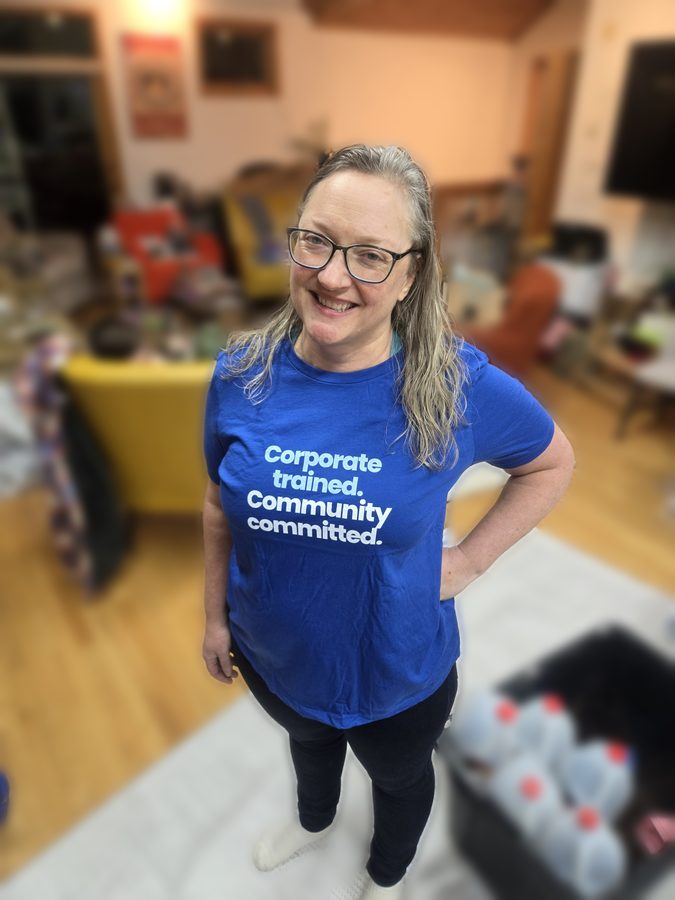 Judy in a shirt that reads Corporate trained, Community committed