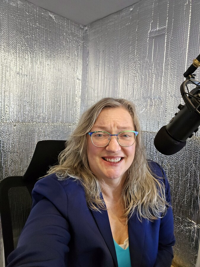 Judy at a podcast microphone
